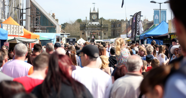 crowds of people browsing stalls at Bishop Auckland Food Festival.